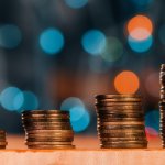 Pilas de monedas en aumento representando la recuperación de la Cartera de Adeudos en un Condominio.